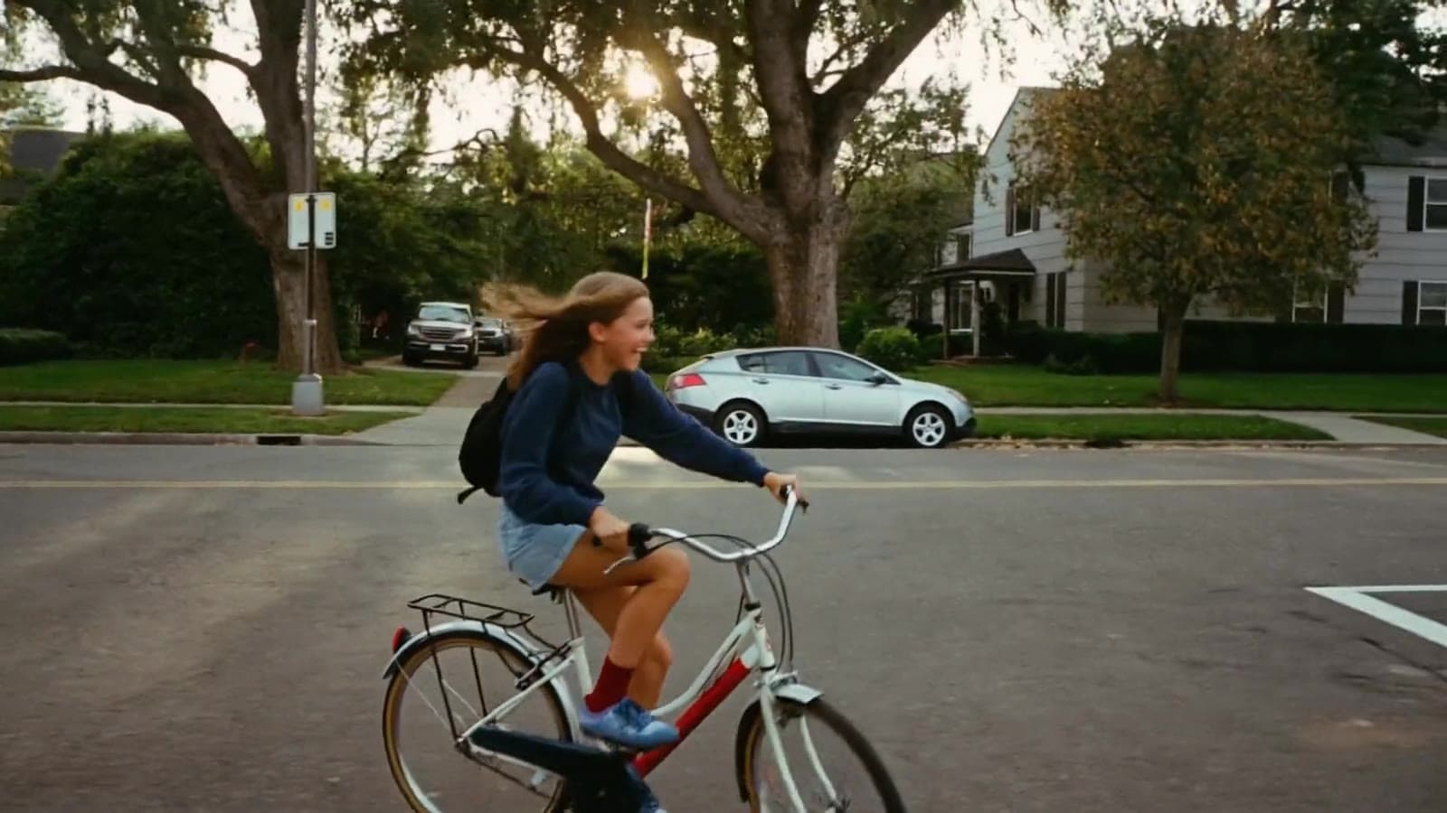 A short film across the places we learn: a girl biking to school at sunrise, a father and son at the kitchen table, a classroom, a campus, a welder, nurses after a night shift, a mother home from work, friends jumping into a lake, a graduation, and a family with sparklers at dusk.